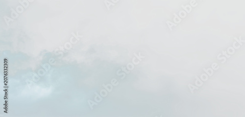 Fotografie Clouds forming an overcast sky with a hint of blue visible during the day, on a