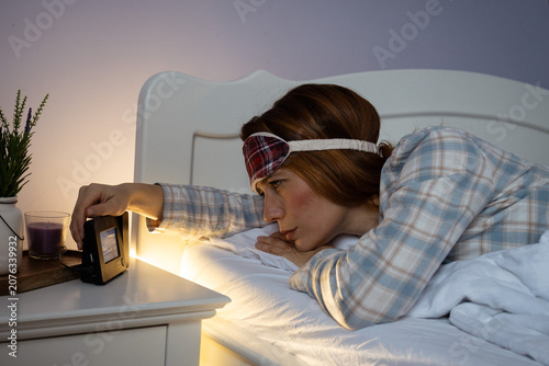 Konstfotografi Woman turning off alarm clock struggling with insomnia