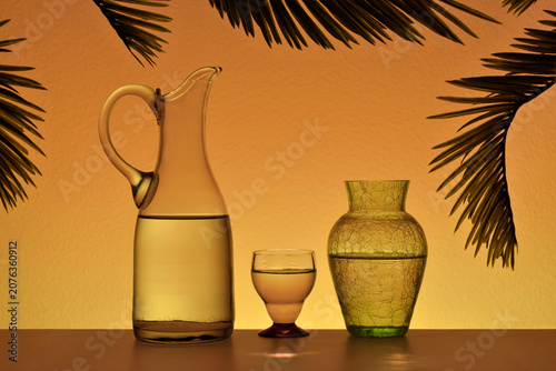 Backlit glassware Palm leaves Orange gradient