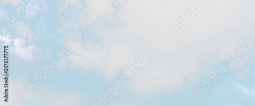 Cuadro en lienzo Clouds in a blue sky with soft white tones creating a light atmosphere above a c