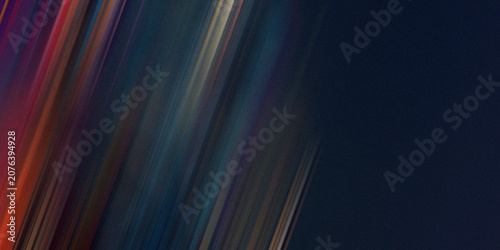 Photos Abstract background with dynamic diagonal streaks of vibrant colors against a dark blue background, conveying motion
