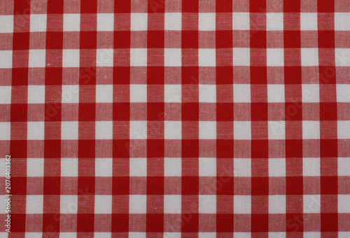 Texture of classic red gingham cotton cloth background. Close up of red and white checkered fabric.