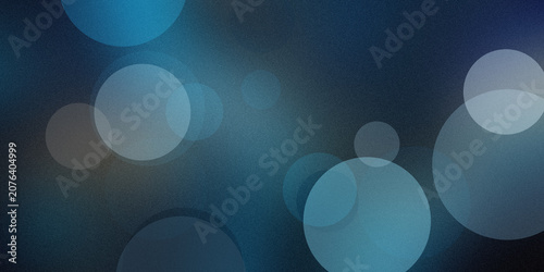 Фотография Abstract blue bokeh background with soft circular light spots and grainy texture for cinematic creative graphic design projects