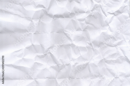 Crumpled paper texture with white background detailed folds and creases visible throughout wrinkled creased