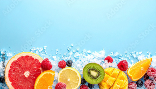 Assorted frozen fruits on crushed ice with clean background