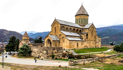 Historic stone church with clock tower in scenic valley.