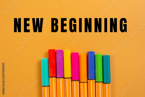 Slika na platnu New beginning text above a line of vibrant markers, symbolizing fresh starts, cr
