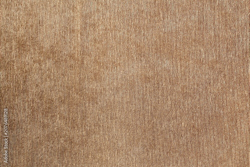 Abstract texture made of brown corduroy fabric.