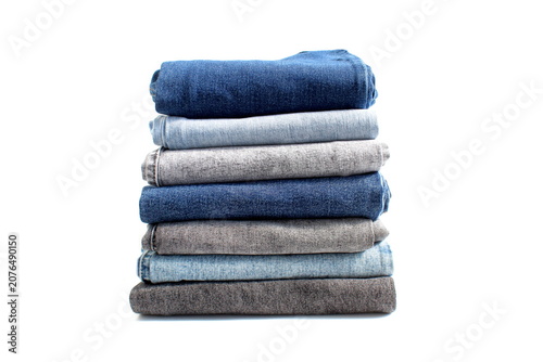 There is a stack of folded jeans on a white background.