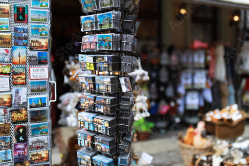 Принти на полотні In a lively street in Berlin, Germany, a small souvenir shop displays colorful p