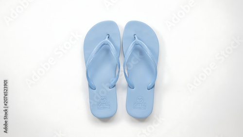Top view of casual blue summer flip flop sandals on white floor with footwear