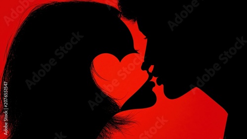 Silhouette of couple kissing with heart shape in negative space.
