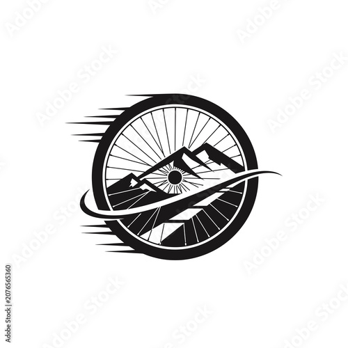 Black and white bicycle wheel with mountain landscape silhouette