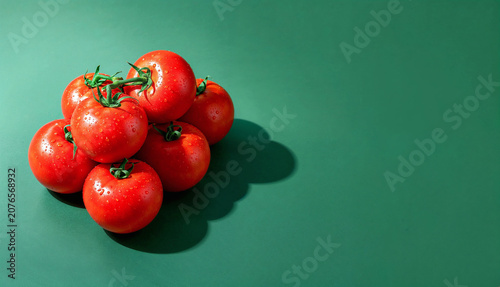Fresh Tomatoes on Green Background