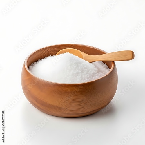 Salt crystals in wooden bowl with scoop isolated on white background.