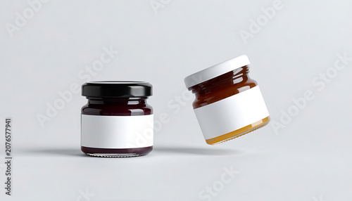 Two small glass jars with blank labels for jam or honey branding mockup