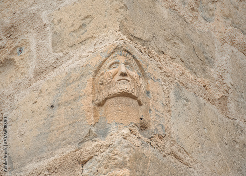 Obraz na płótnie Corner of Forgotten Myths Where a Weathered Stone Face Still Holds Its Story