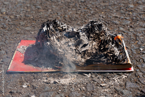 Book Burning on Asphalt Ground Symbolizing Censorship and Destruction