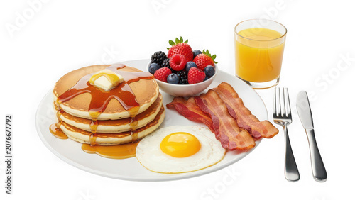 A breakfast plate with pancakes, bacon, fried egg, berries and orange juice isolated on transparent background