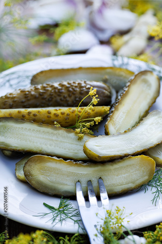 Close up of traditional pickled cucumbers, pickled using the natural fermentation method, on a plate