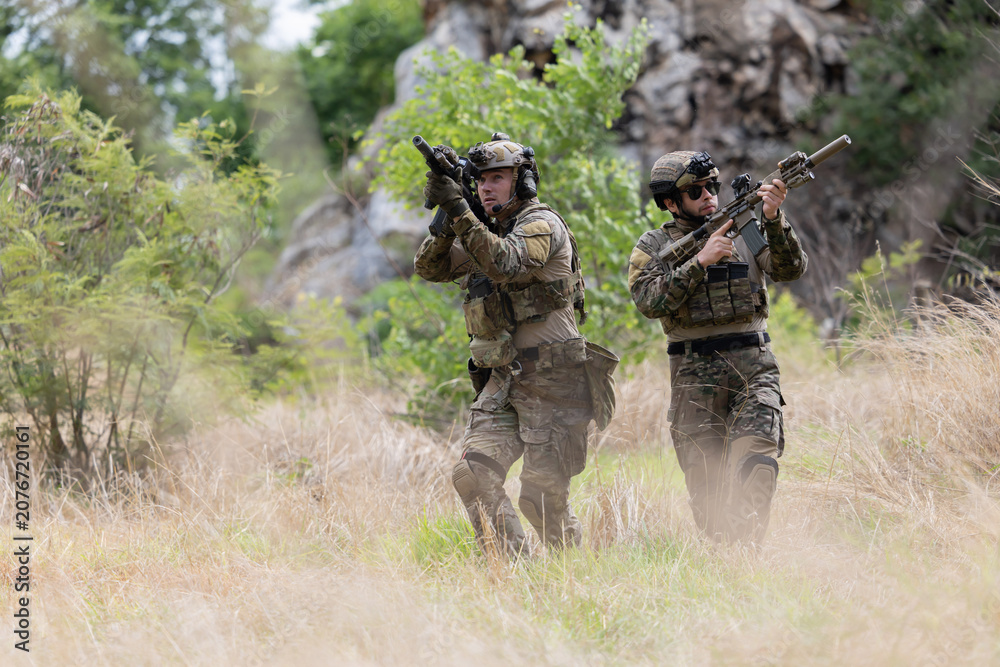 Fototapeta premium Military participate in a patrol in forrest terrain