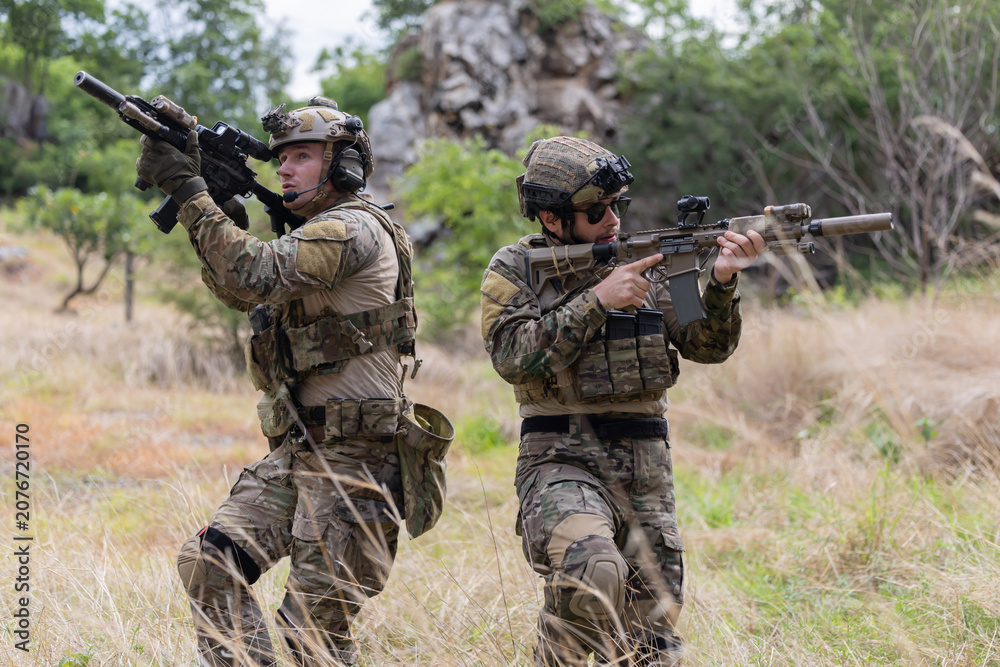Fototapeta premium Military participate in a patrol in forrest terrain
