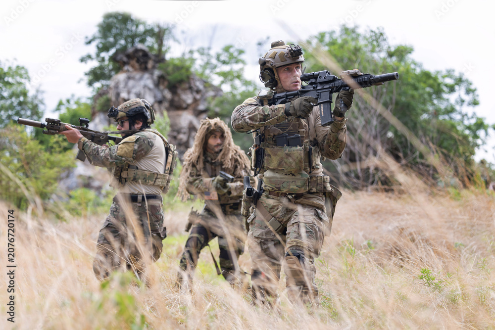 Fototapeta premium Military participate in a patrol in forrest terrain