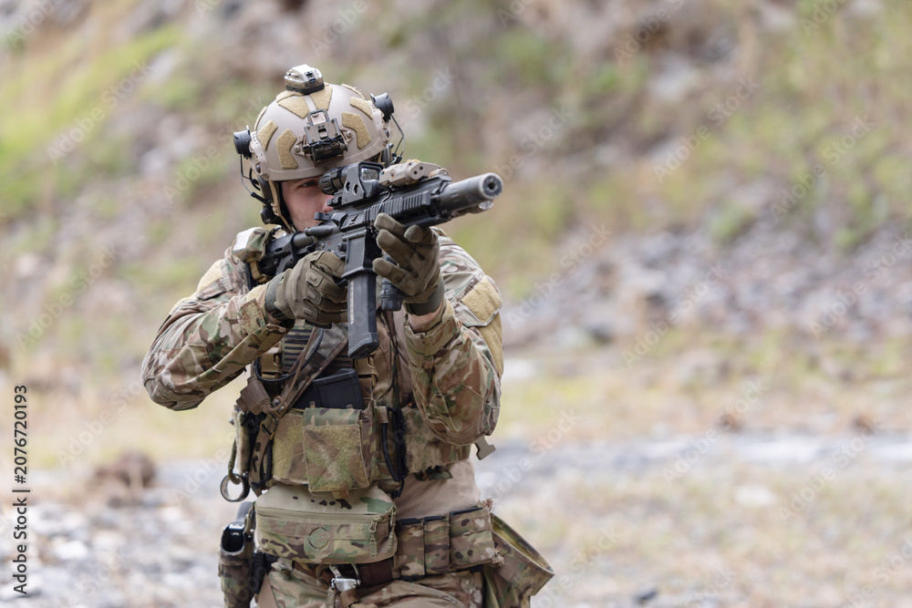 Fototapeta premium Military participate in a patrol in a rocky terrain
