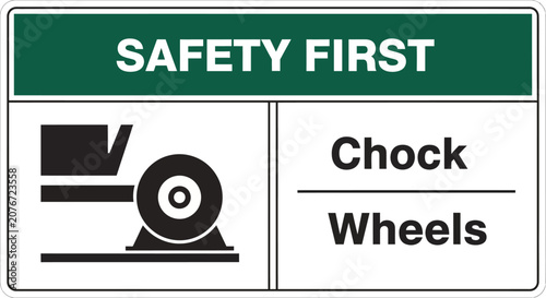 A safety sign with a wheel and chock warning is posted indoors.