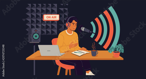 A man recording a podcast in a studio with a microphone and laptop on a wooden desk