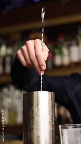 Bartender preparing a craft cocktail in a premium luxury restaurant. Close-up shots of mixing, pouring and garnishing. Elegant bar atmosphere, professional mixology, nightlife concept.