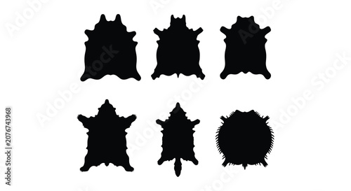 Bild auf Leinwand Collection of animal hide silhouettes in varying shapes a black and white presen