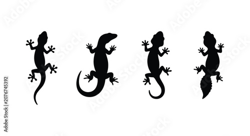 Quadro su tela Four lizard silhouettes in varying poses against a white background a minimalist