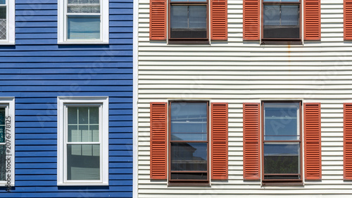 Cuadro en lienzo Architectural detail of adjacent houses with blue and white siding and orange sh