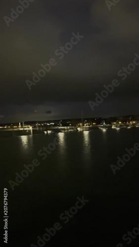 Konstanz, Germany - October 19, 2025: Evening views of the waterfront, harbor and city streets at Lake Constance with urban lights, reflections and pedestrians. Editorial use only.
