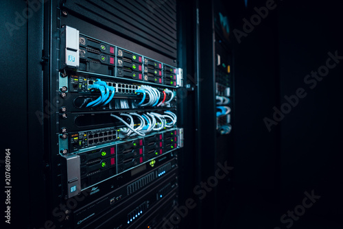 View of a server rack with network switches and blue ethernet cables in a data center in Los Angeles, California, United States.