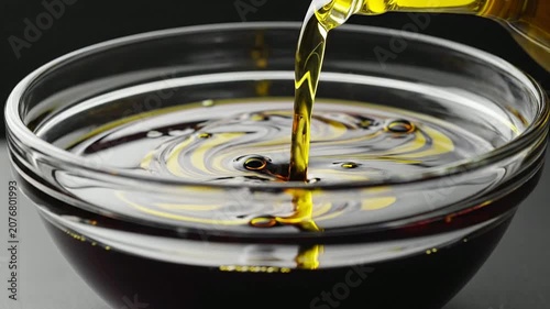 Close-Up Shot Of A Rich Dark Balsamic Vinegar Pouring Into A Glass Bowl Emphasizing The Smooth Flow And Vibrant Colors Ideal For Culinary And Gastronomy Visuals