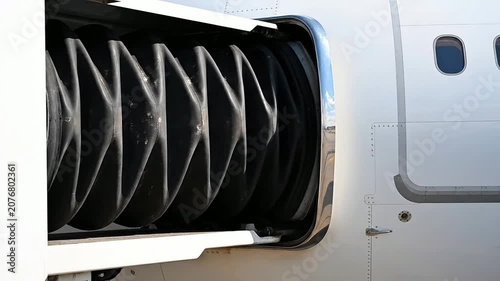 Close-Up Static Shot Of The Corrugated Rubber Bellows Of A Jet Bridge Firmly Sealed To An Aircraft For Efficient Boarding Operations