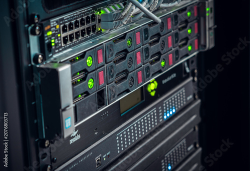 View of a server rack with networking equipment, blinking green status lights, and storage drives in Los Angeles, California, United States.