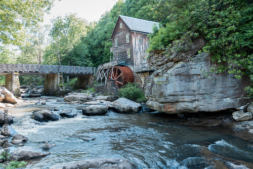 Obraz na plátně Historic grist mill with waterwheel beside mountain stream