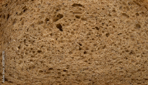 Brown slice of bread close up texture background