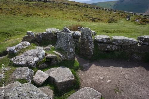Ancient stone circle in grassy hills - Dartmoor - England