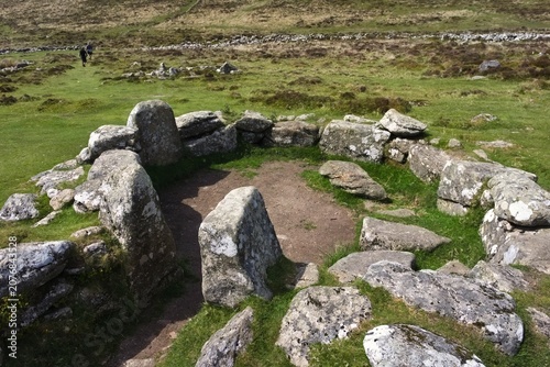ancient stone circle ruins on grass - Dartmoor - England