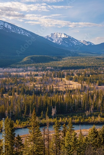 Kananaskis River And Forest Beneath Cloudy Mountain Skies