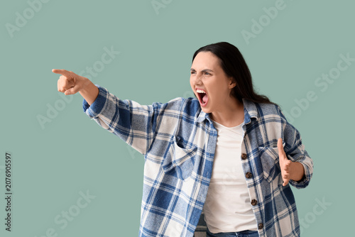 Screaming young woman point...