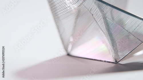 Abstract geometric form with transparent surfaces and shadows on white backdrop