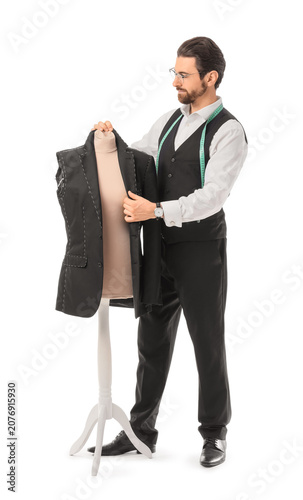 Male tailor sewing jacket on white background