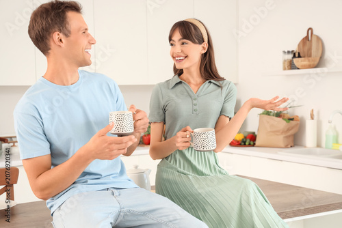Young couple with cups of c...