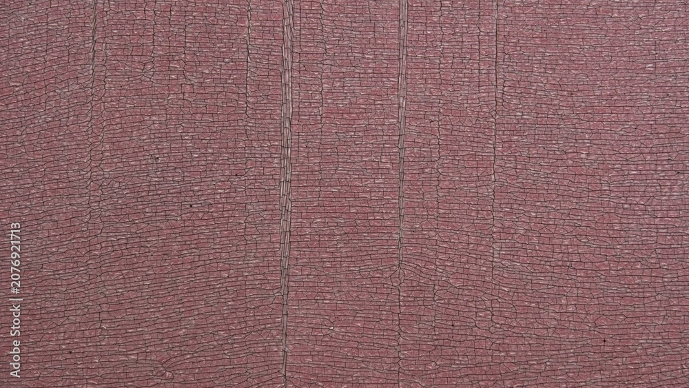 Fototapeta premium Abstract background texture featuring heavily cracked and weathered pinkish plastic or PVC surface, ideal for grunge conceptual designs.