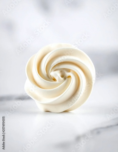 swirled vanilla buttercream frosting piped in a rosette shape on a marble surface, perfect for bakery branding, dessert decoration, pastry menu